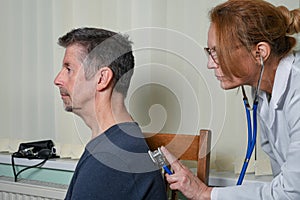 Doctor examining a patient at an appointment.