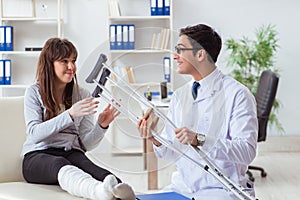 The doctor examining patient with broken leg