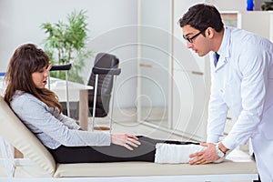The doctor examining patient with broken leg