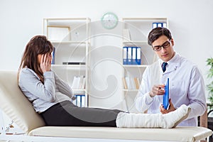 The doctor examining patient with broken leg