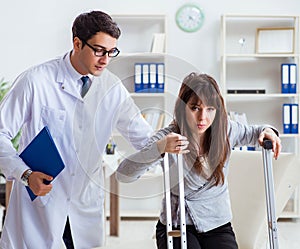 Doctor examining patient with broken leg