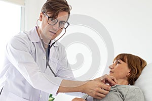 The doctor is examining the patient in the hospital