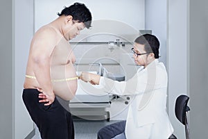 Doctor examining a patient obesity