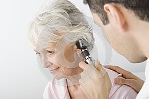 Doctor Examining Patient's Ear Using Otoscope