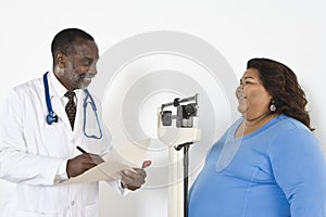 Doctor Examining Patient's Weight