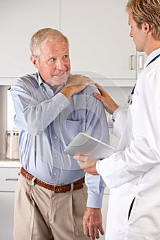 Doctor Examining Patient With Shoulder Pain