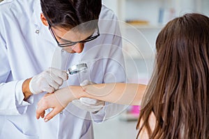 The doctor examining patient skin in hospital