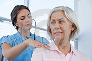 Doctor examining a patient with stethoscope