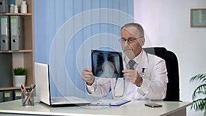 Doctor examining patients chest X-ray, lung disease diagnostics, healthcare