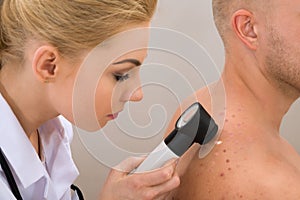 Doctor examining pigmented skin