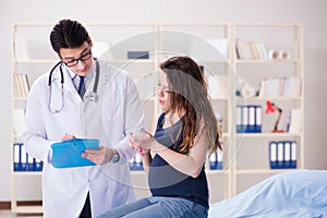 The doctor examining pregnant woman patient