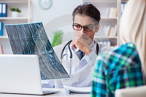 The doctor examining x-ray images of patient