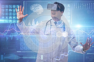 The doctor examining x-ray images using virtual reality glasses