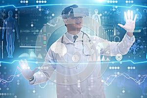 The doctor examining x-ray images using virtual reality glasses