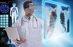 The doctor examining x-ray images using virtual reality glasses