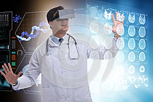 The doctor examining x-ray images using virtual reality glasses