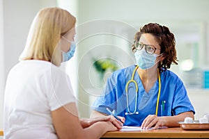 Doctor examining sick patient. Ill woman in clinic