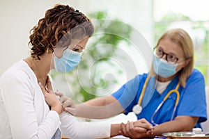 Doctor examining sick patient. Ill woman in clinic