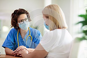 Doctor examining sick patient. Ill woman in clinic