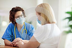 Doctor examining sick patient. Ill woman in clinic