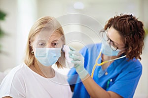 Doctor examining sick patient. Ill woman in clinic