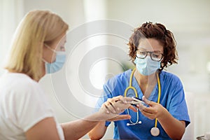 Doctor examining sick patient. Ill woman in clinic