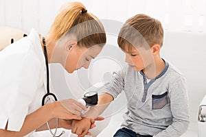 Doctor Examining Skin Of Little Boy