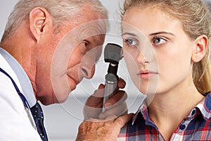 Doctor Examining Teenage Girl's Ears