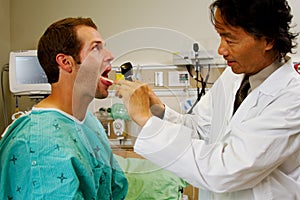 Doctor examining throat