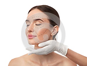 Doctor examining woman`s face before plastic surgery on background photo