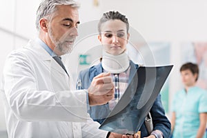 Doctor examining a young female patient`s x-ray