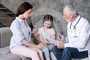 Doctor explain treatment plan for patient girl at home appointment