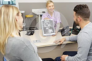 doctor explain ultrasound result to couple at hospital