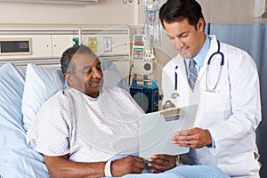 Doctor Explaining Consent Form To Senior Patient