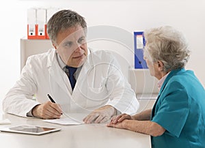 Doctor explaining diagnosis to his senior female patient