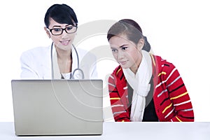 Doctor explaining illness via laptop