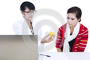 Doctor explaining medicine dosage to patient photo