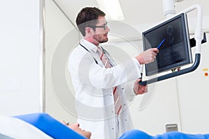 Doctor explaining patient MRI scan on screen