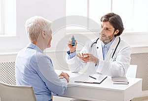 Doctor explaining pills schedule to senior patient