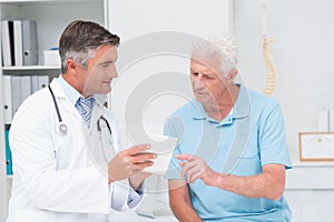 Doctor explaining prescription to senior patient