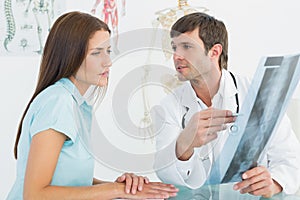 Doctor explaining spine xray to female patient