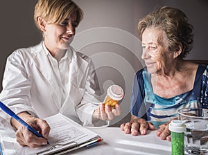 Doctor explains to elderly daily dose of medication