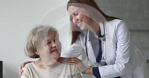 Doctor express friendly professional support to older woman patient
