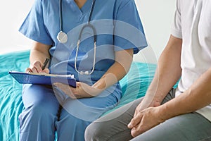 Doctor filling out a document for discharge from the hospital photo