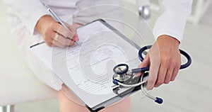 Doctor filling out paper medical history of patient in clinic closeup 4k movie slow motion