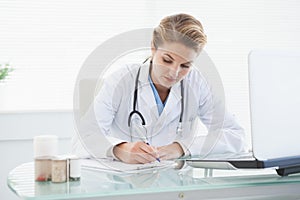 Doctor filling out prescriptions photo