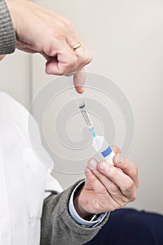 Doctor Filling Syringe For Vaccination