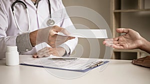 Doctor filling up an history form while consulting to patient and recommend treatment methods and how to rehabilitate