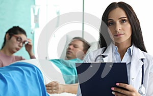 Doctor with folder is standing in palette sick man