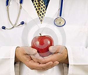 Doctor Gently Holding Red Apple photo